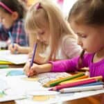 children drawing in coloring books
