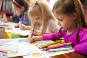 children drawing in coloring books