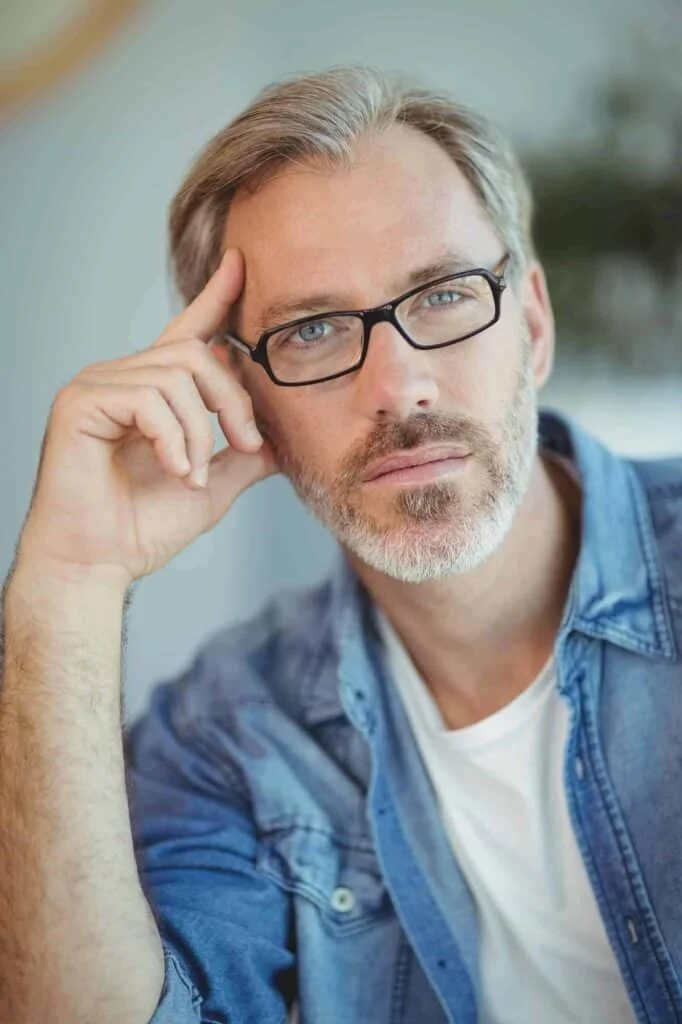 Thoughtful man in glasses with a serious expression.